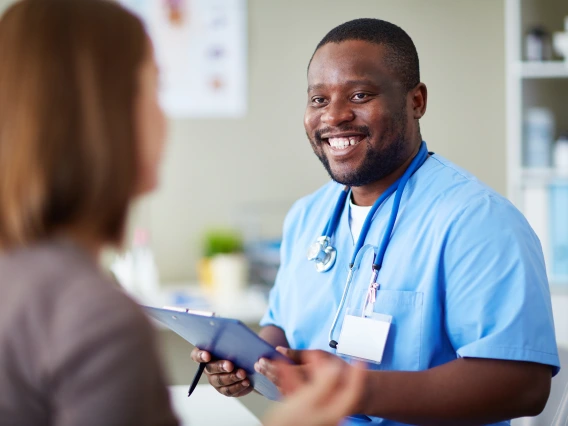 A healthcare worker interacts with a patient.